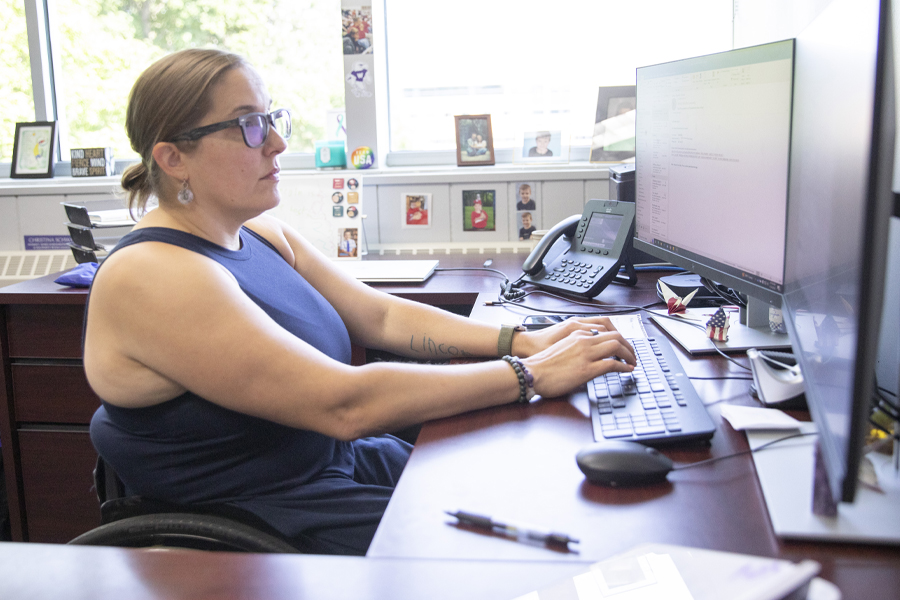 A person works on a computer at a desk.